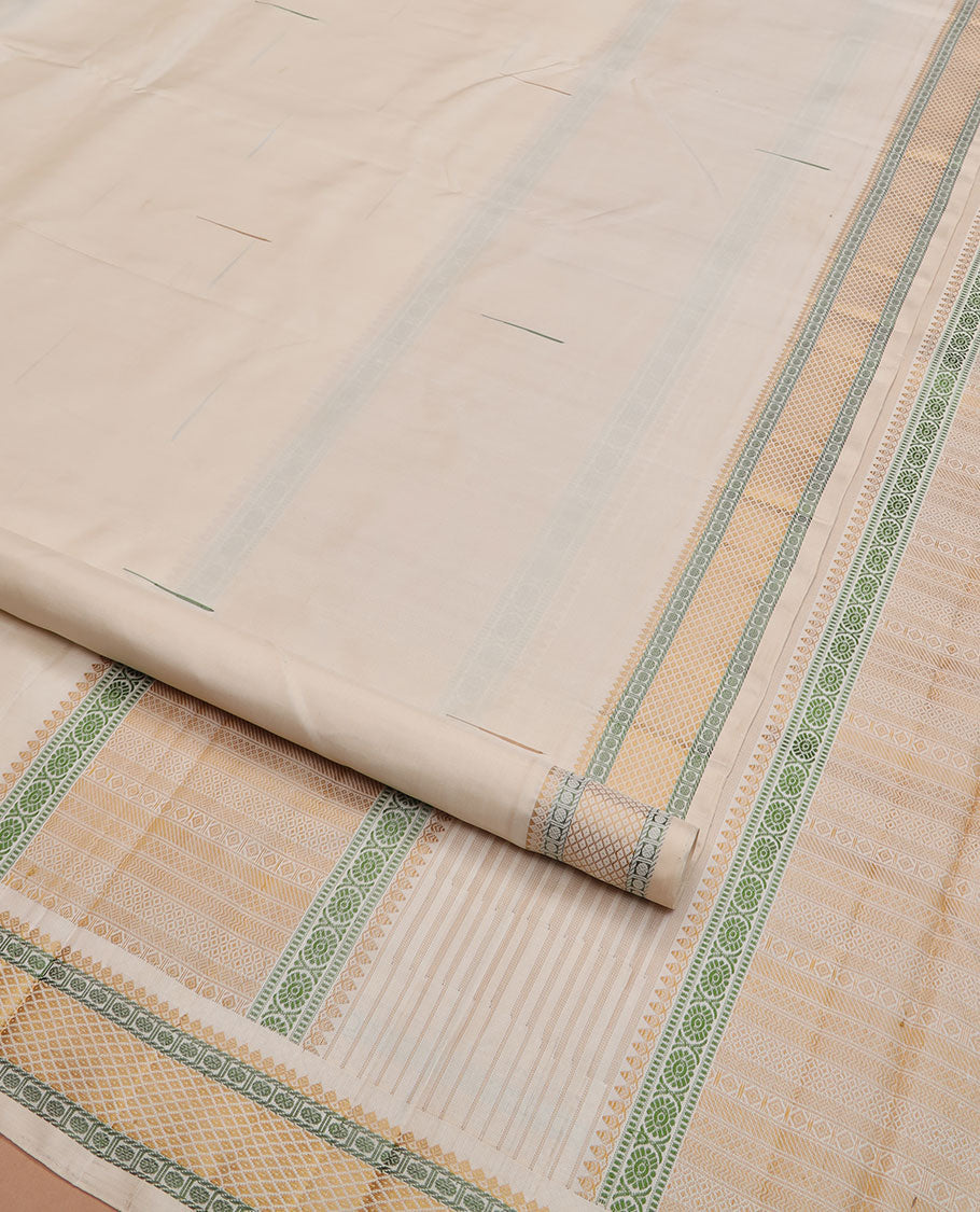 Cream malli mokku Kanchipuram silk saree, self-border of thilakam mokku, rudraksham, and mayil kann, and pallu of thilakam mokku, chakram, seppu rekku, and geometric patterns