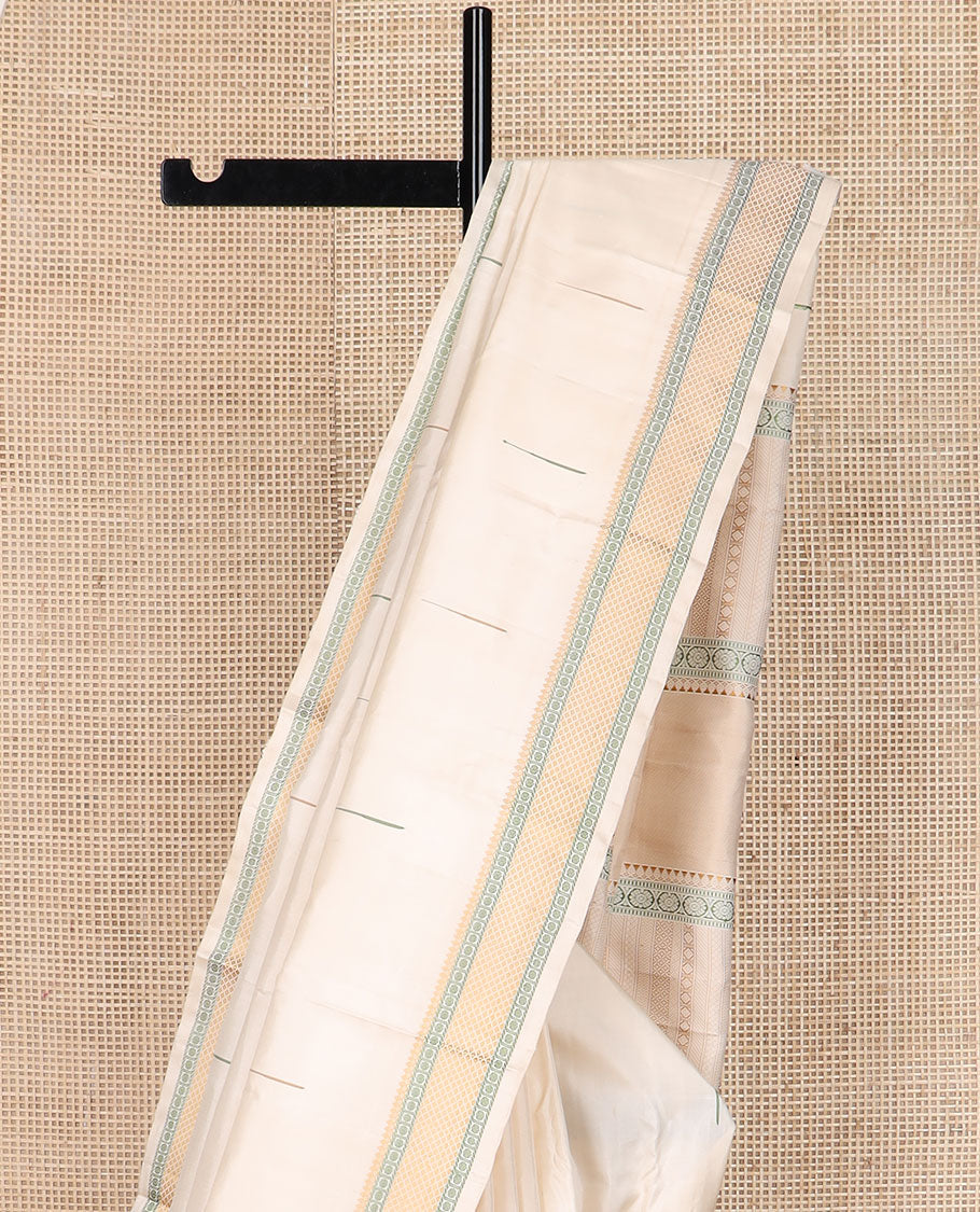 Cream malli mokku Kanchipuram silk saree, self-border of thilakam mokku, rudraksham, and mayil kann, and pallu of thilakam mokku, chakram, seppu rekku, and geometric patterns