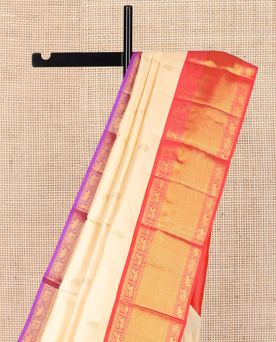 Cream manga buttas Kanchipuram silk saree, contrast ganga jamuna border of thilakam mokku, muthu, kuthirai, and kodi mayil and yaanai designs, and jaal pallu