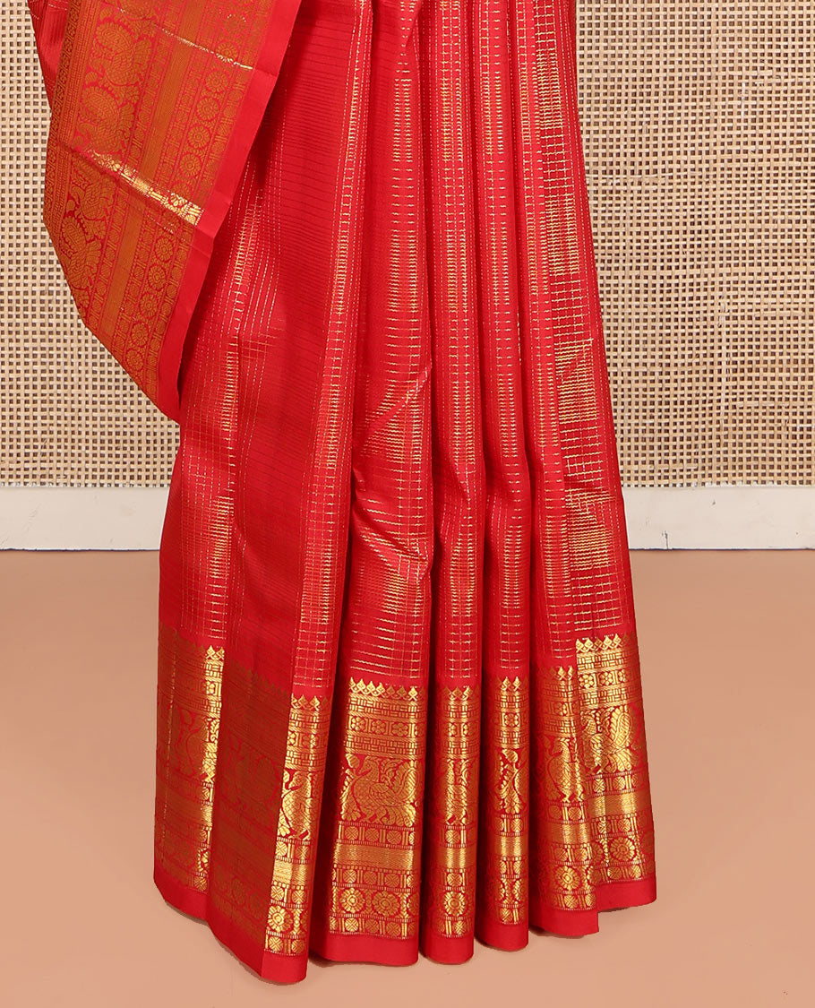 Red Kanchipuram Silk Saree, Gleamed Up with Mayil Butta Enclosed Checks, Highlighted by One-Sided Border of Thilakam Mokku, Kamalam, Mayil, Chakram, and Rudraksham Designs, Pallu of Chakram and Mayil Designs, and Comes Without a Blouse