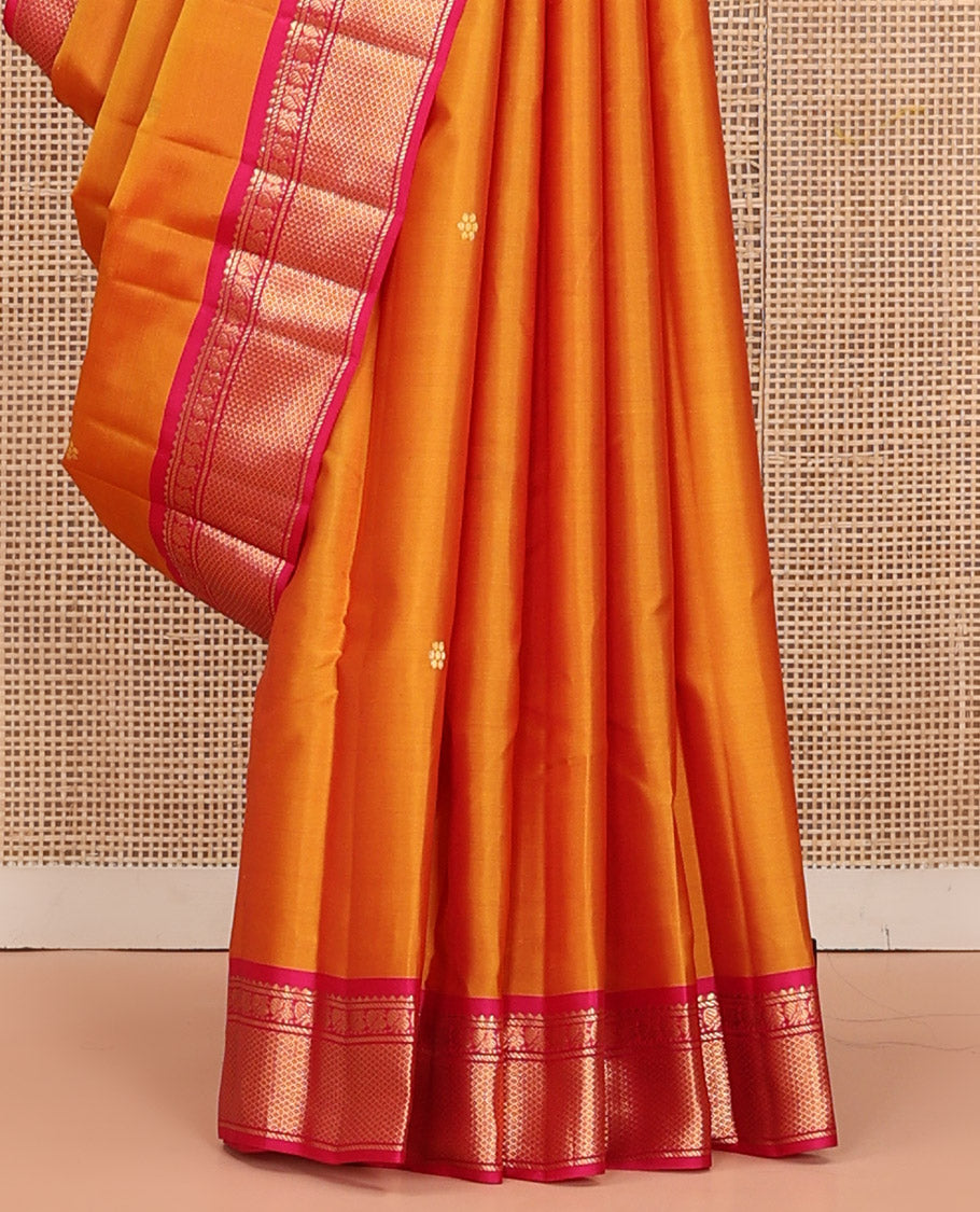 Orange Kanchipuram Silk Saree Decked Up with Zari Buttas, Complemented by Contrasting Border of Rekku, Banaras, Mayil, and Mayil Kann Designs, Pallu Mirroring the Same Border Design, and Paired with a Contrast Blouse