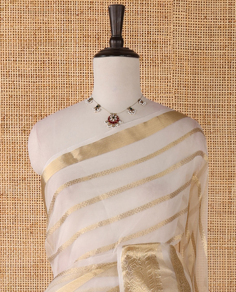 Half-white veldhari zari design semi-organza saree, gold zari floral creeper border, zari design pallu & blouse