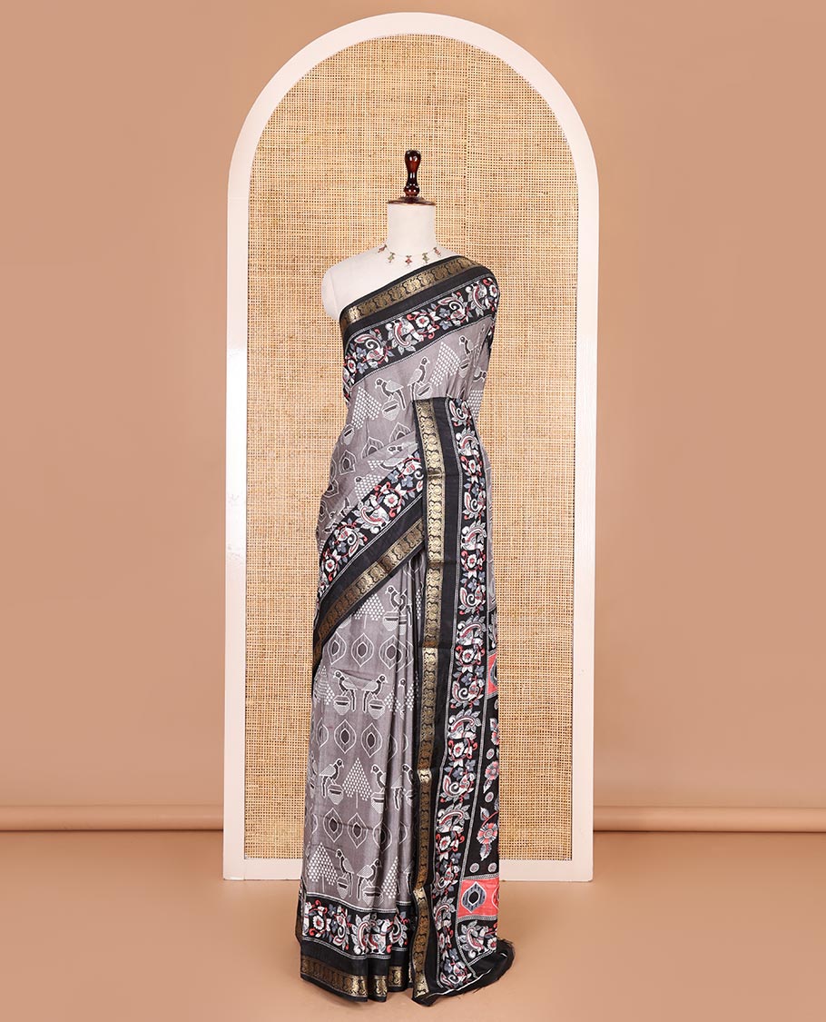 Grey pochampally ikkat parrot motifs printed dola silk saree, contrast border of kalamkari printed with zari work, kalamkari peacock printed pallu, and contrast zari design blouse
