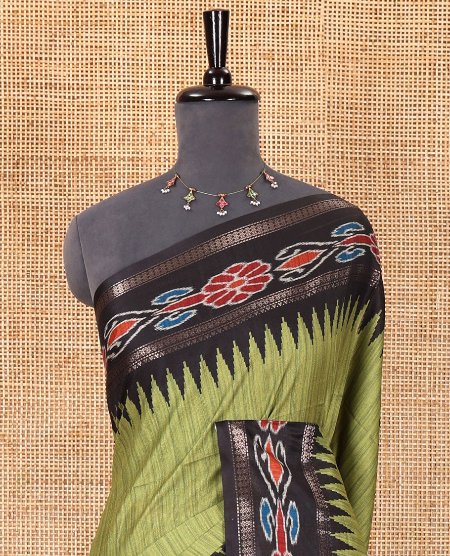 Olive green plain Katan silk saree, contrast temple ikkat floral printed border, ikkat floral printed pallu, and ikkat printed blouse