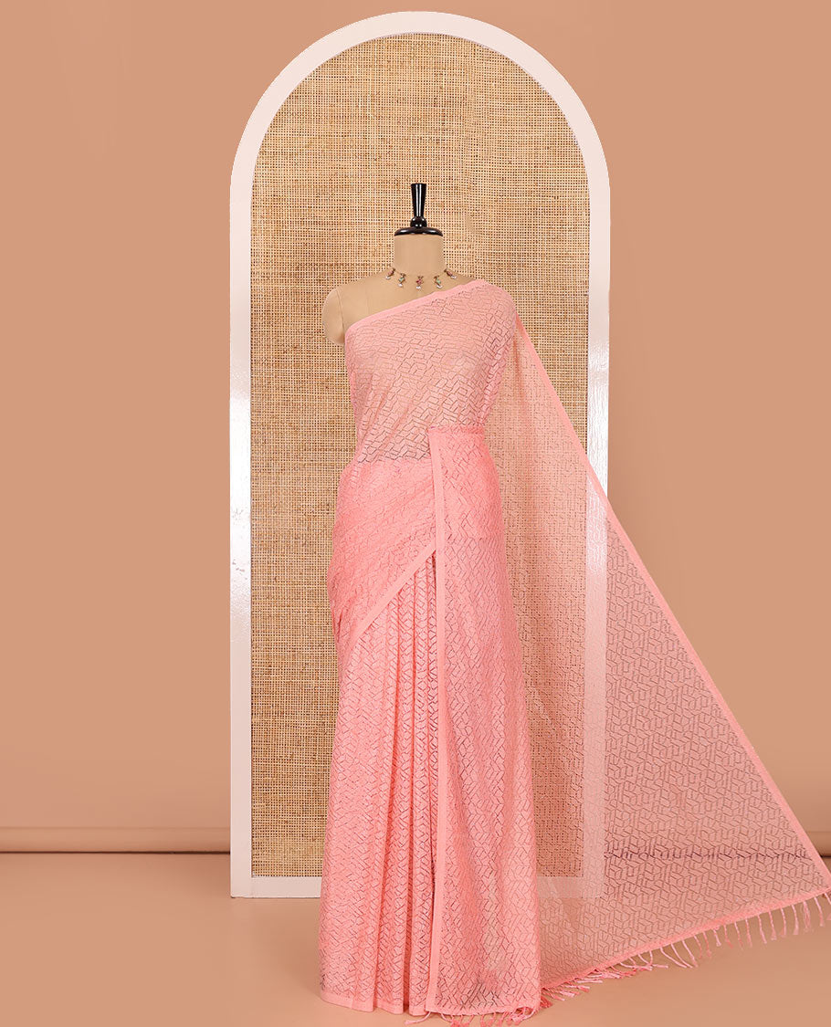 Borderless pink sparkling glittered russel net saree, self-pallu and a floral print with zig-zag embroidered blouse