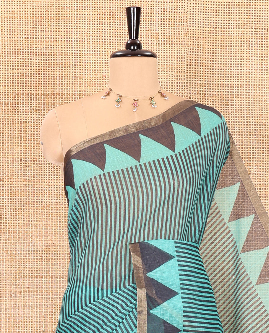 Green vertical stripes printed linen cotton saree, a temple-printed border, big polka dot printed pallu, and a printed blouse