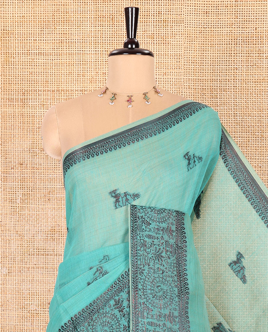 Rama Chanderi Cotton Saree Delicately Woven with Warli Motifs All Over Its Body, Featuring a Subtly Sparkled Border Depicting Warli Village Motifs, Subtly Striped Pallu, and Paired with a Matching Blouse