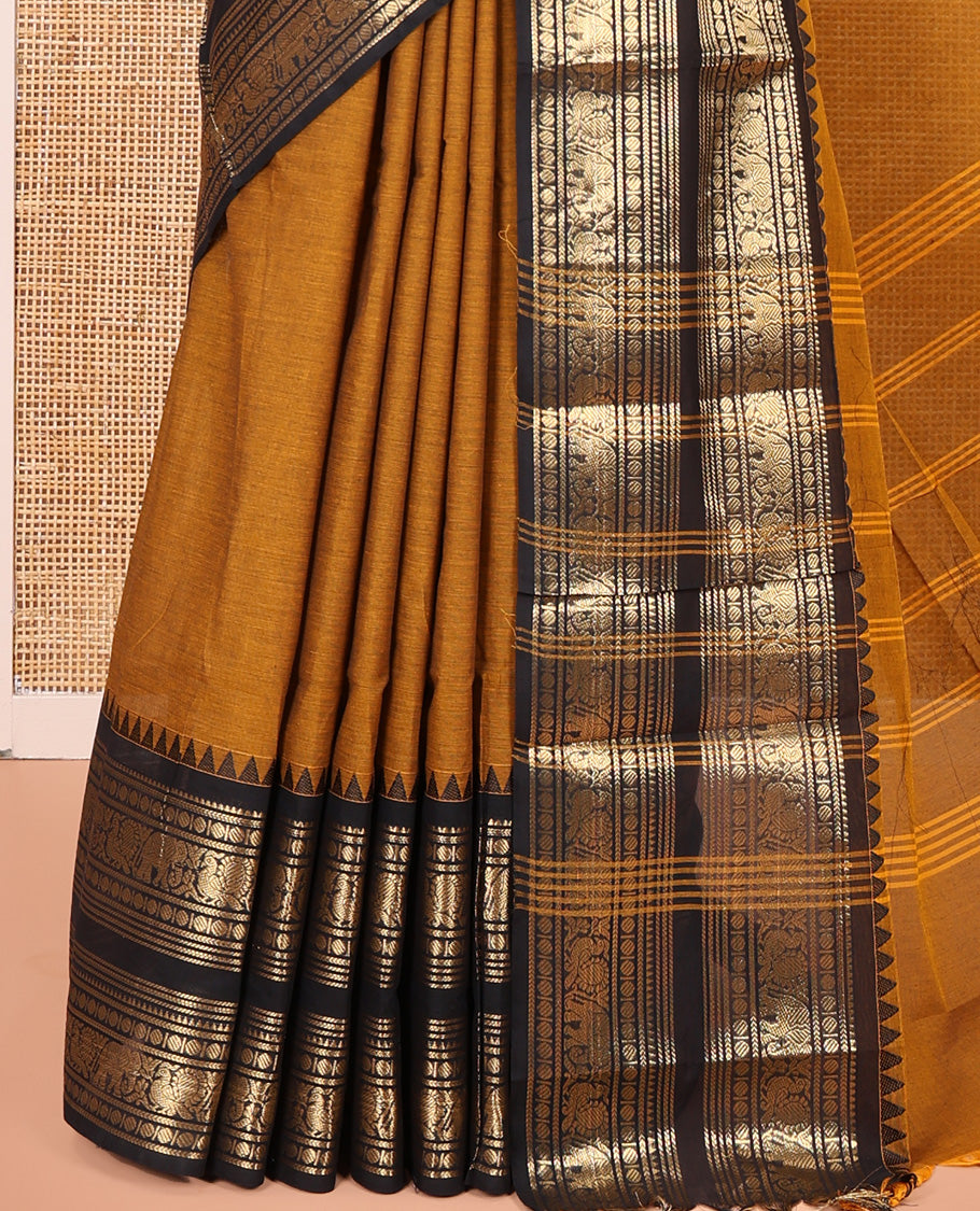 Mustard Plain Chettinad Cotton Saree, Complemented by a Contrast Rettai Pettu Dual-Color Zari Border of Temple, Coin, Elephant, and Peacock Designs, Subtly Striped Pallu, and Paired with a Matching Blouse