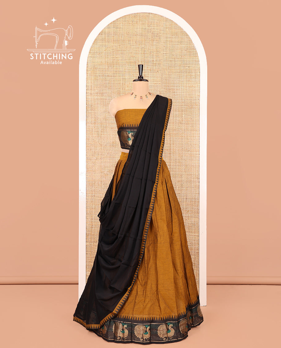 Mustard-Black Chettinad Cotton Half-Saree Set Featuring a Plain Skirt, Contrast Temple Peacock Motif Border, a Matching Blouse, and a Contrast Temple Dhavani