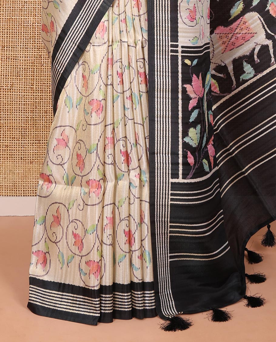 Chikku-black floral vine printed tissue patola saree, contrast striped border, pallu of floral and Pichwai cow motifs print, and a plain blouse