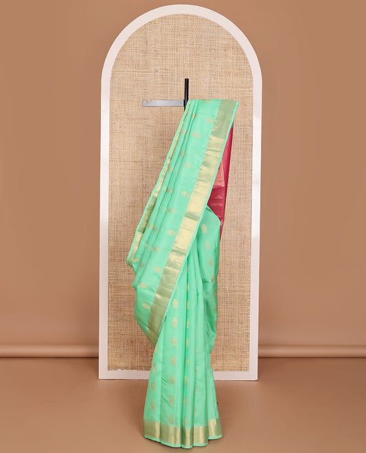 Green zari buttas Vasundhara elite silksaree, zari border of thilakam mokku, neli & zari stripes & contrast jaal pallu