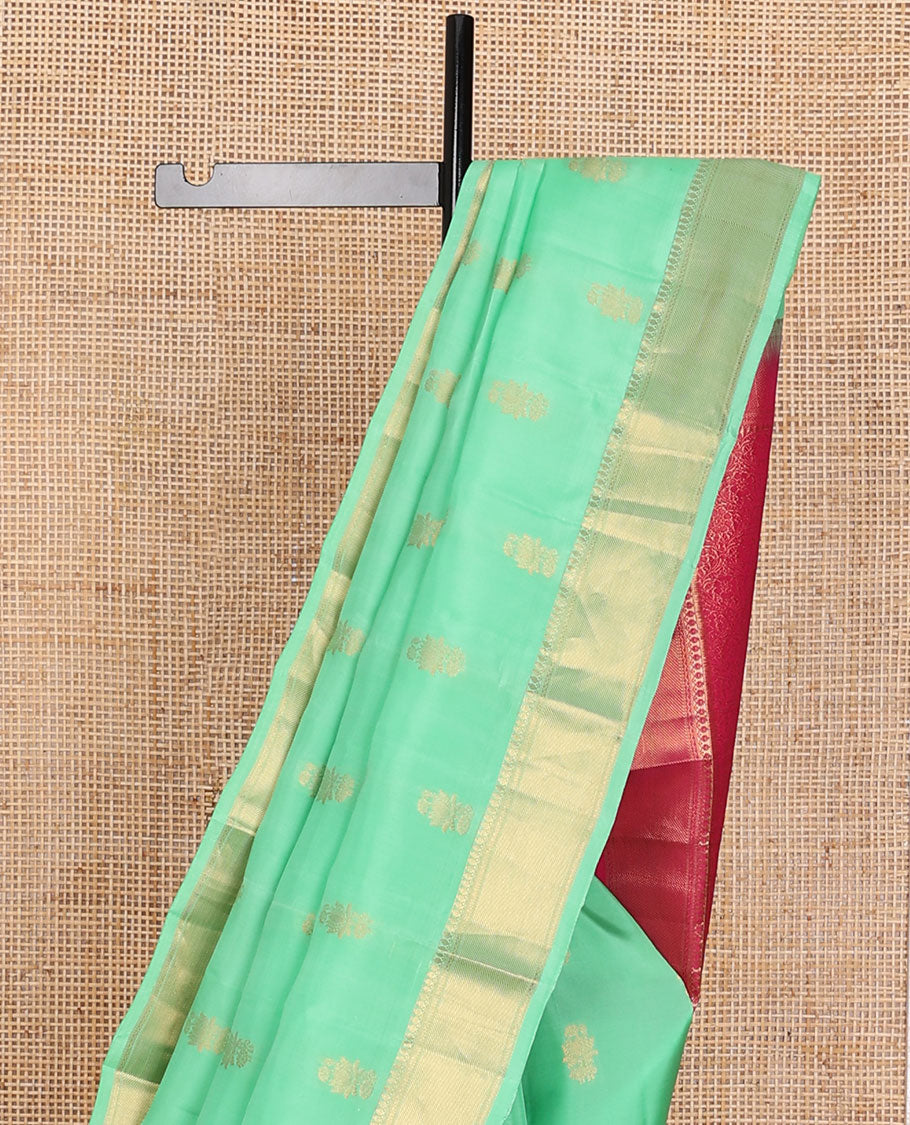 Green zari buttas Vasundhara elite silksaree, zari border of thilakam mokku, neli & zari stripes & contrast jaal pallu