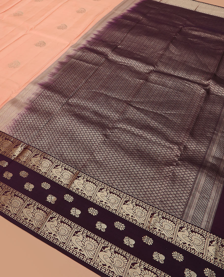 Peach butta silk saree, contrast border of rekku, diamond, muthu, and mayil chakram designs, and jaal pallu