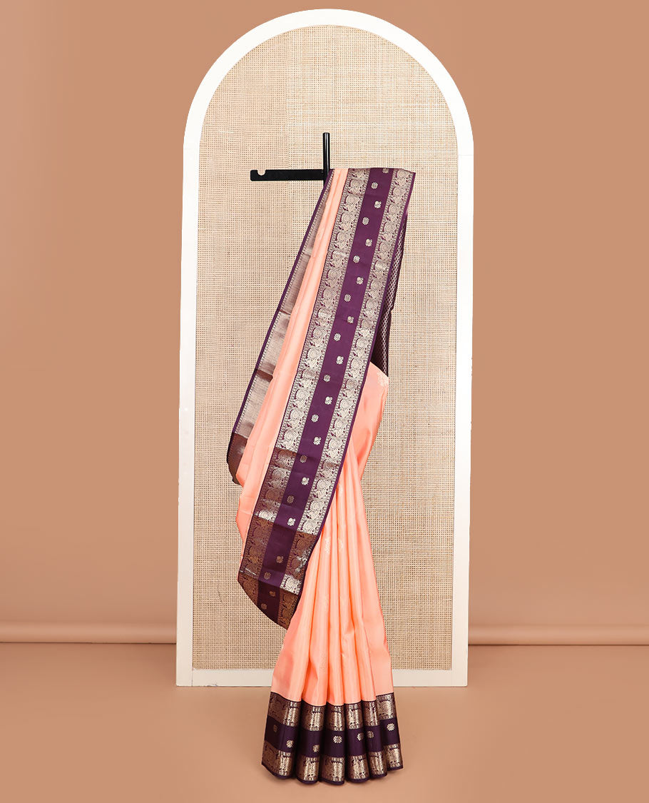 Peach butta silk saree, contrast border of rekku, diamond, muthu, and mayil chakram designs, and jaal pallu