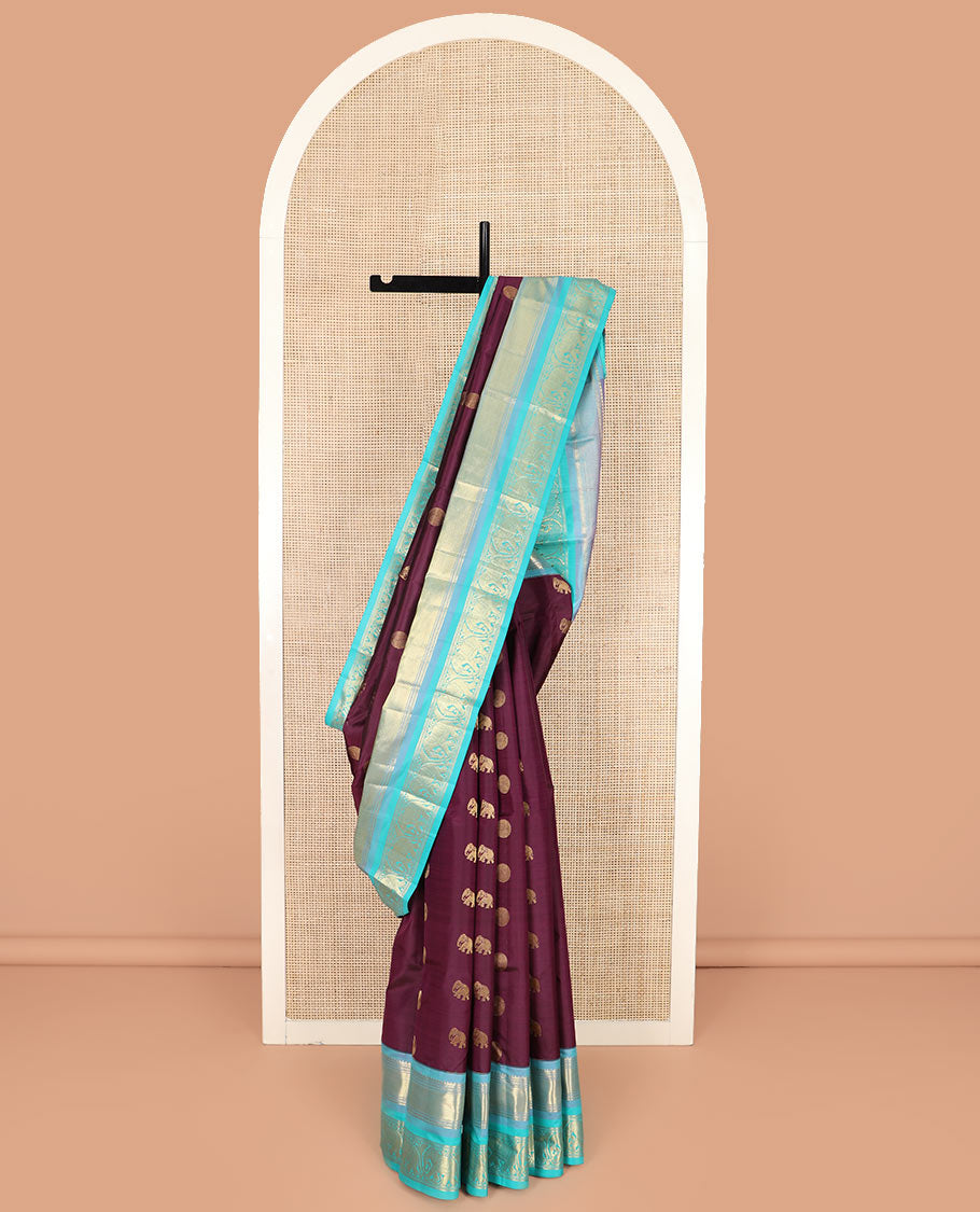Purple Vasundhara Silk Saree Beautified with Yaanai and Poun Buttas, Complemented by a Contrast Border of Neli, Mayil Kann, Muthu, Banaras, and Yaanai Designs, Pallu Woven in Jaal Design, and Paired with a Contrast Blouse