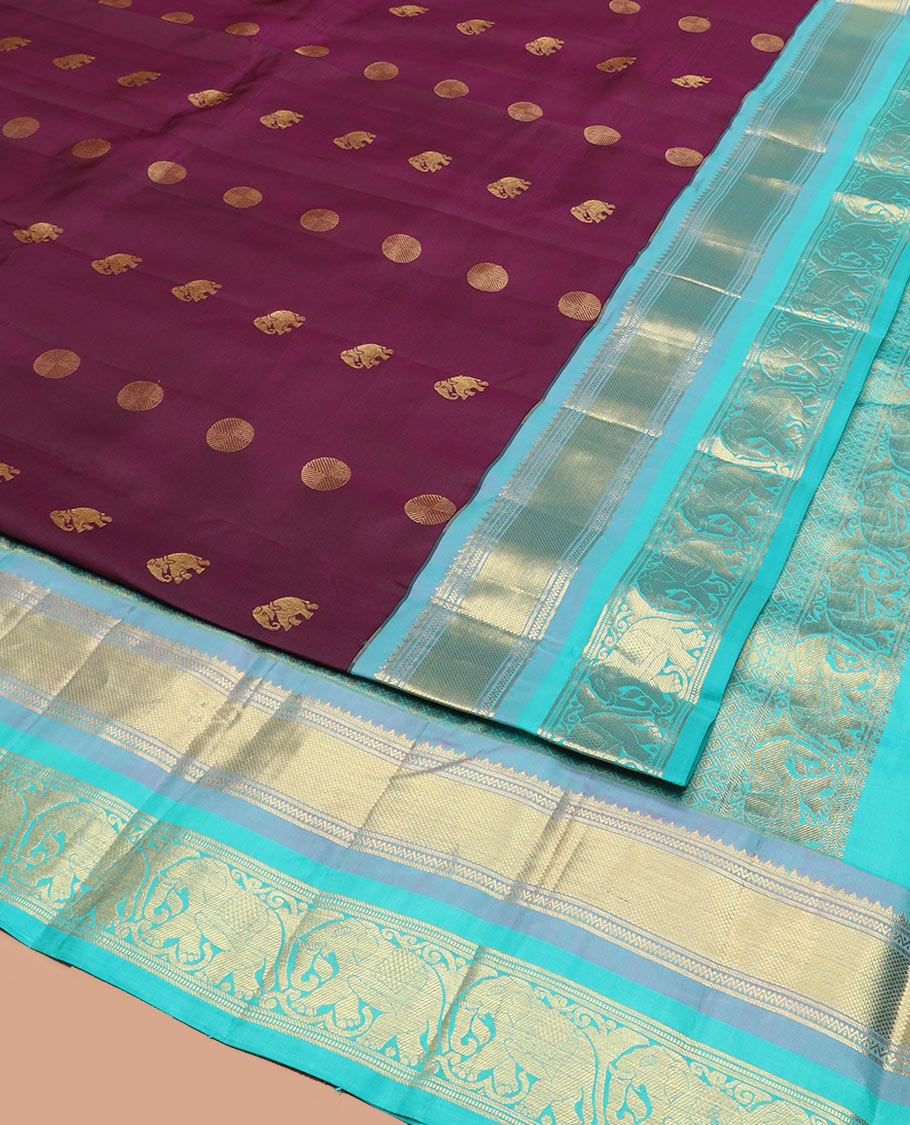 Purple Vasundhara Silk Saree Beautified with Yaanai and Poun Buttas, Complemented by a Contrast Border of Neli, Mayil Kann, Muthu, Banaras, and Yaanai Designs, Pallu Woven in Jaal Design, and Paired with a Contrast Blouse