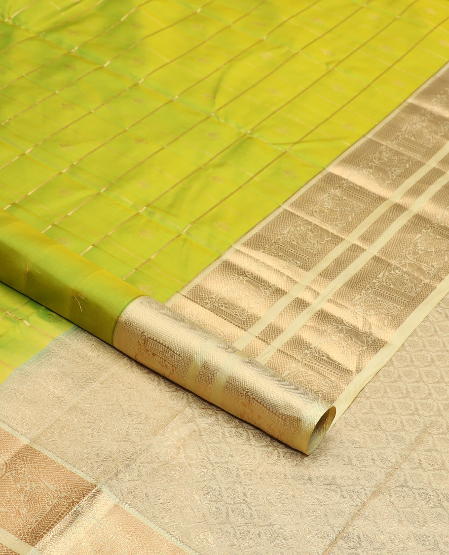 Green zari buttas silk saree, contrast border of kuyil kann, banaras, and mayil designs, and ogee patterned pallu