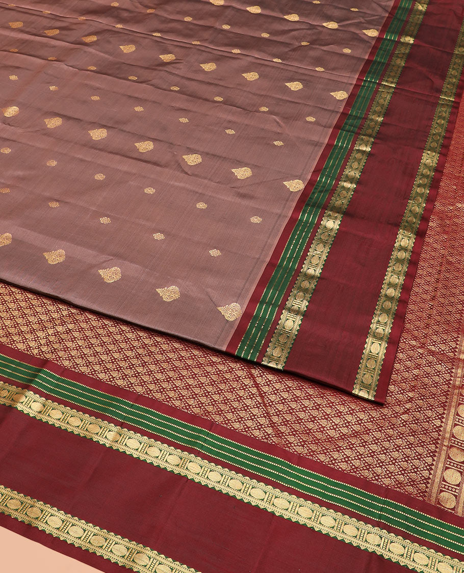 Brown Vasundhara Silk Saree Richly Detailed with Zari Buttas, Complemented by a Contrast Varisai Pettu Border of Muthu, Rekku, and Rudraksham Designs, Intricately Designed Pallu, and a Contrast Blouse
