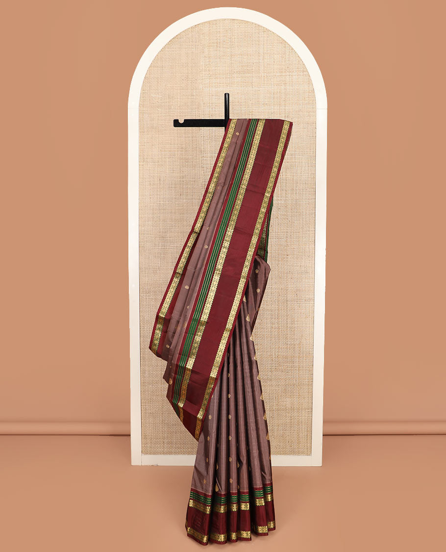 Brown Vasundhara Silk Saree Richly Detailed with Zari Buttas, Complemented by a Contrast Varisai Pettu Border of Muthu, Rekku, and Rudraksham Designs, Intricately Designed Pallu, and a Contrast Blouse