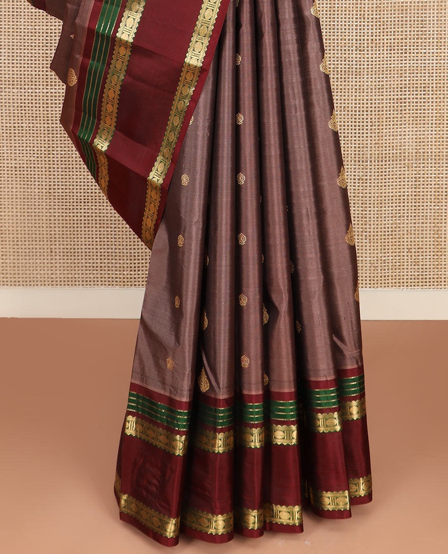 Brown Vasundhara Silk Saree Richly Detailed with Zari Buttas, Complemented by a Contrast Varisai Pettu Border of Muthu, Rekku, and Rudraksham Designs, Intricately Designed Pallu, and a Contrast Blouse