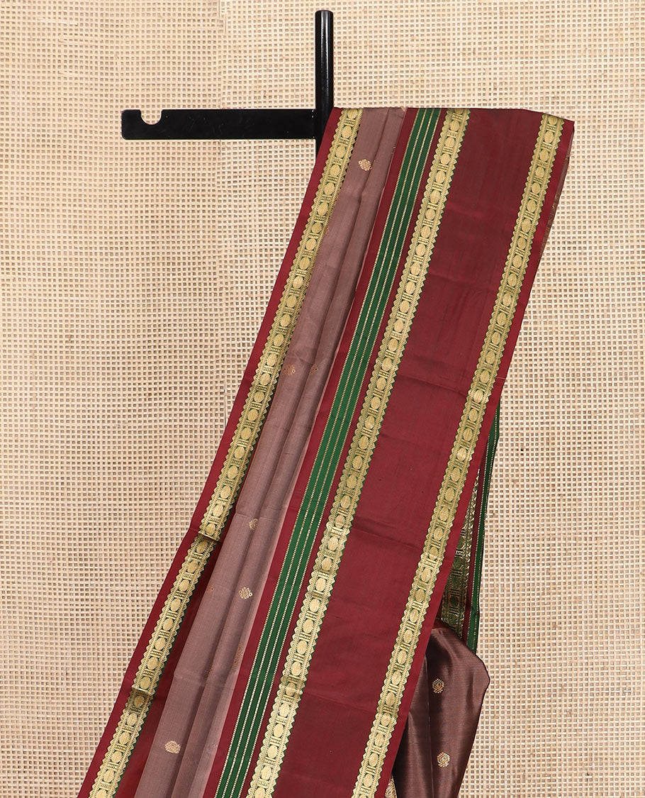 Brown Vasundhara Silk Saree Richly Detailed with Zari Buttas, Complemented by a Contrast Varisai Pettu Border of Muthu, Rekku, and Rudraksham Designs, Intricately Designed Pallu, and a Contrast Blouse