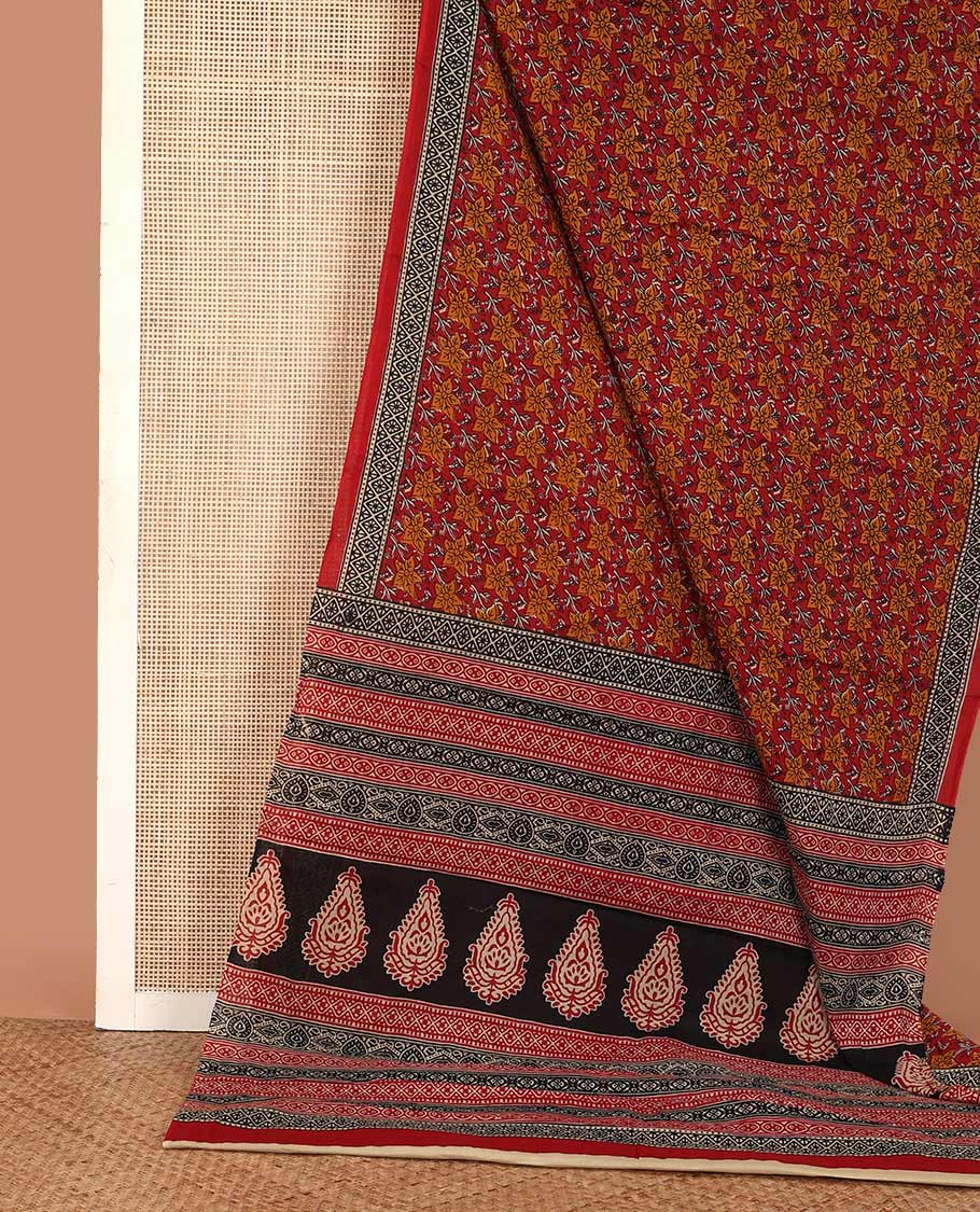 Red floral printed mul mul cotton saree, diamond patterns printed border, and pallu of intricate print