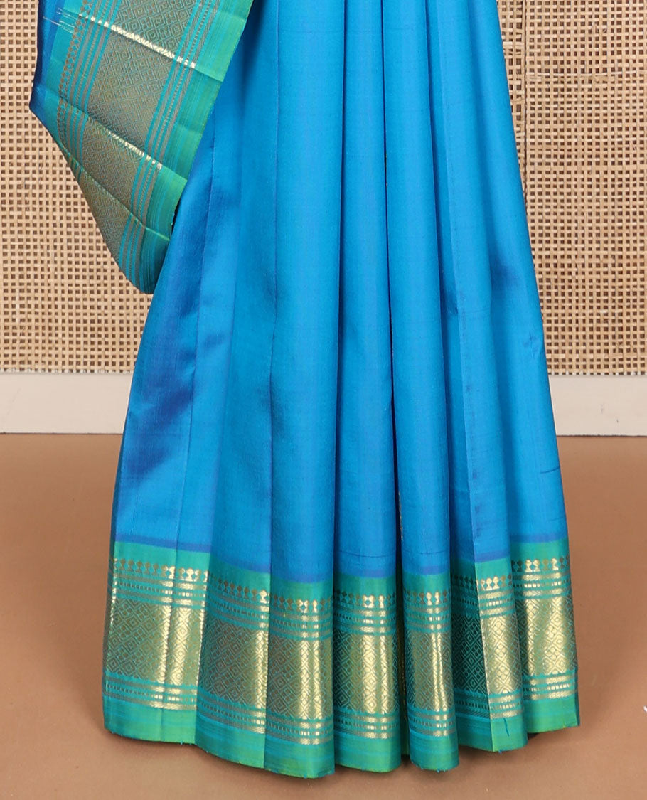 Blue zari buttas Kanchipuram silk saree, contrast one-sided border of paneer sombu, banaras, muthu, and jaal designs, and zari design pallu