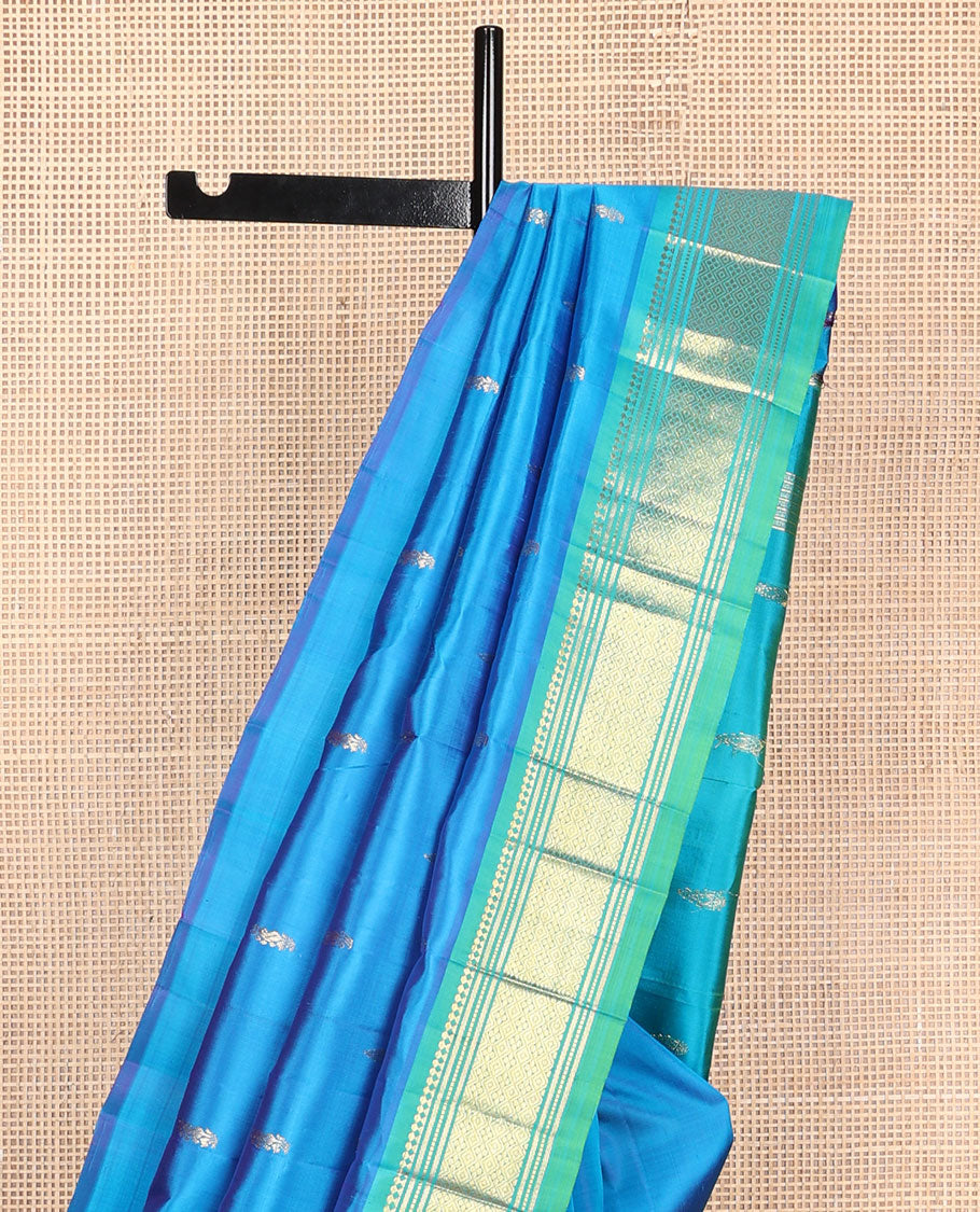 Blue zari buttas Kanchipuram silk saree, contrast one-sided border of paneer sombu, banaras, muthu, and jaal designs, and zari design pallu