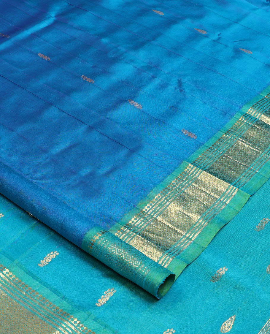 Blue zari buttas Kanchipuram silk saree, contrast one-sided border of paneer sombu, banaras, muthu, and jaal designs, and zari design pallu