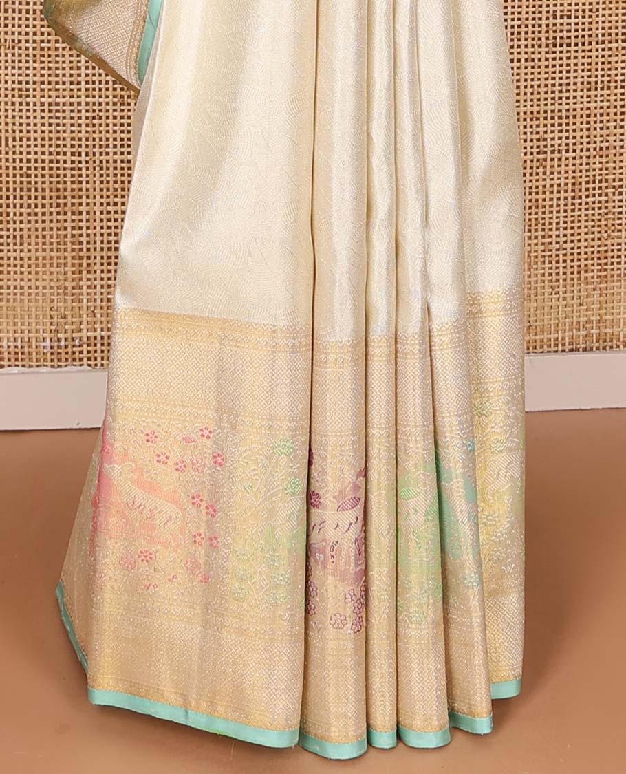 Cream jacquard Kanchipuram silk saree, zari border of mayil kann, and meenakari maan designs, and geometric pallu