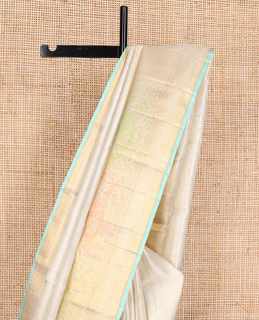 Cream jacquard Kanchipuram silk saree, zari border of mayil kann, and meenakari maan designs, and geometric pallu