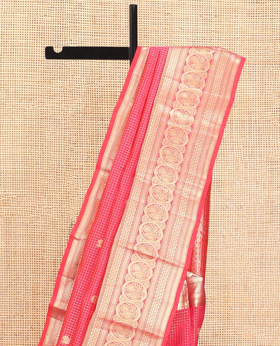 Red Vasundhara Silk Saree, Enriched with Zari Buttas and Checks All Over Its Body, Highlighted by Zari Border of Rekku, Mayil Kann, Vanki, Then Kuli Kann, and Round Mayil Designs, Grand Pallu of Butta Enclosed Checks, and Paired with a Matching Blouse