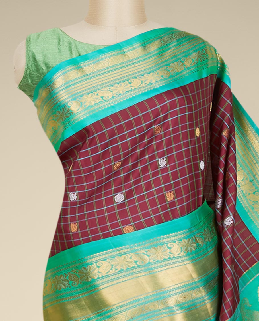 Maroon gadwal checked silksaree with mayil chakra buttas, contrast zari border & pallu of paisley, floral & argyle style