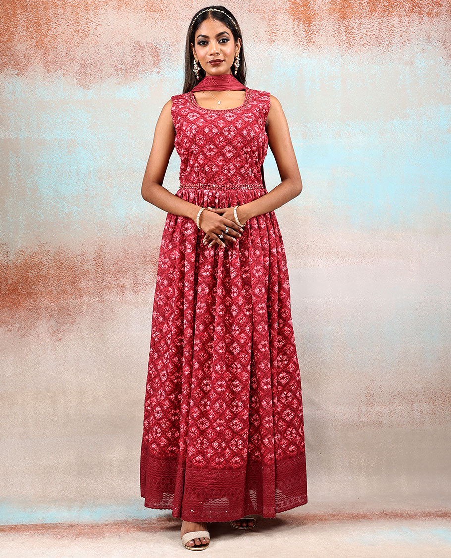 Red printed georgette Anarkali features intricate motifs, mirror work neck & thread embroidered border & dupatta