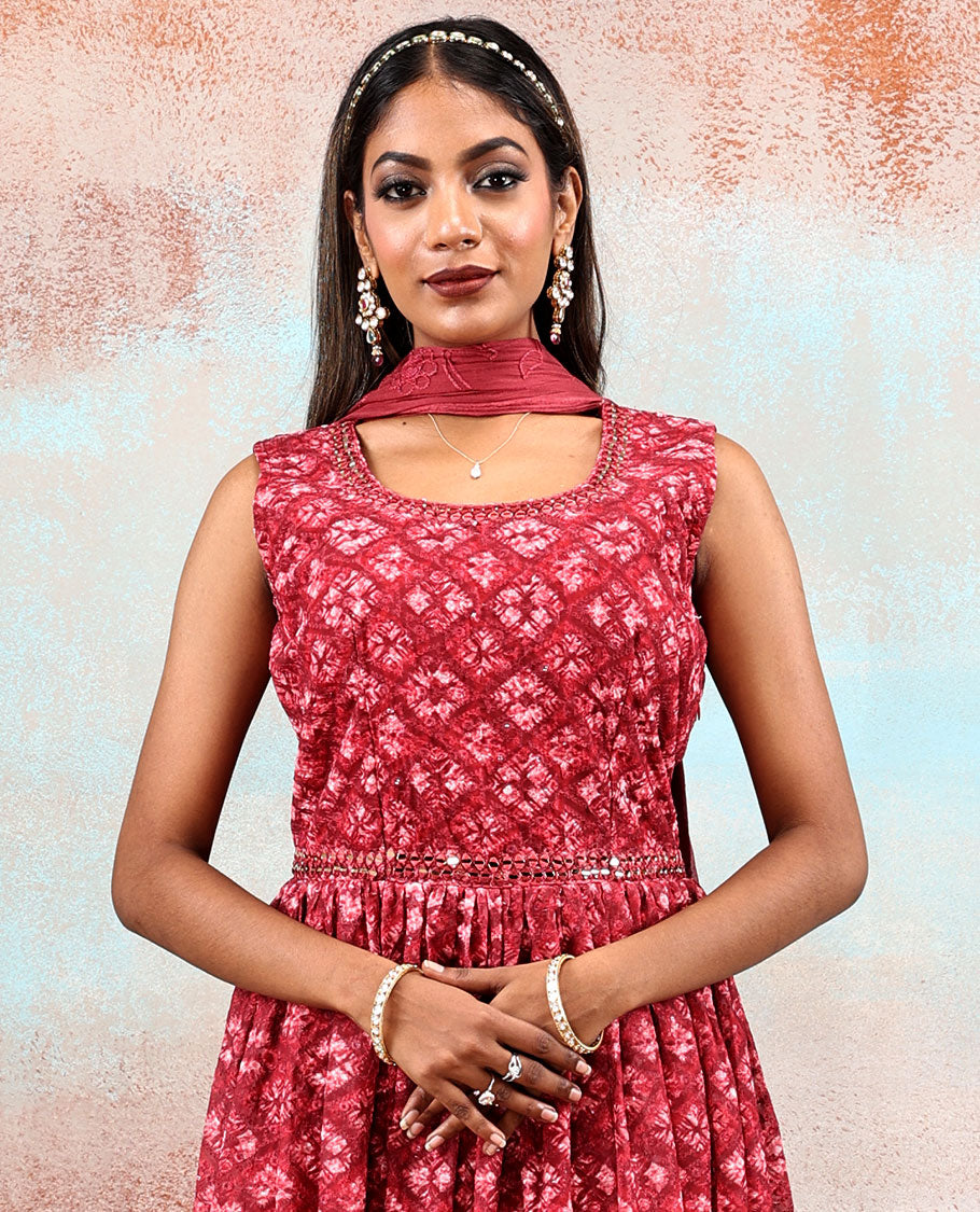 Red printed georgette Anarkali features intricate motifs, mirror work neck & thread embroidered border & dupatta