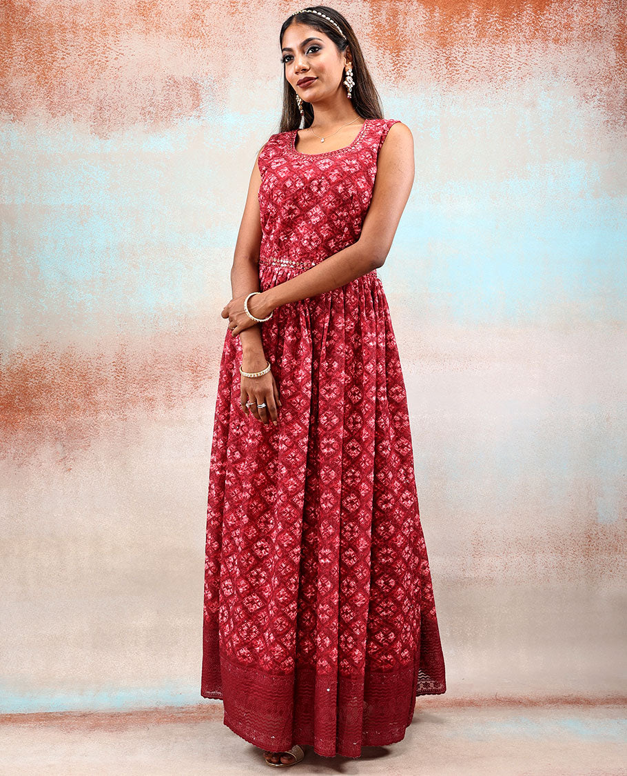 Red printed georgette Anarkali features intricate motifs, mirror work neck & thread embroidered border & dupatta