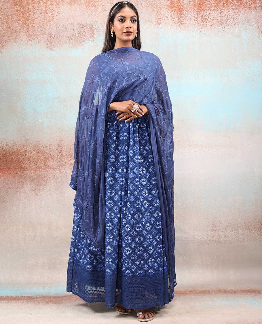 Blue printed georgette Anarkali features intricate motifs, mirror work neck & thread embroidered border & dupatta