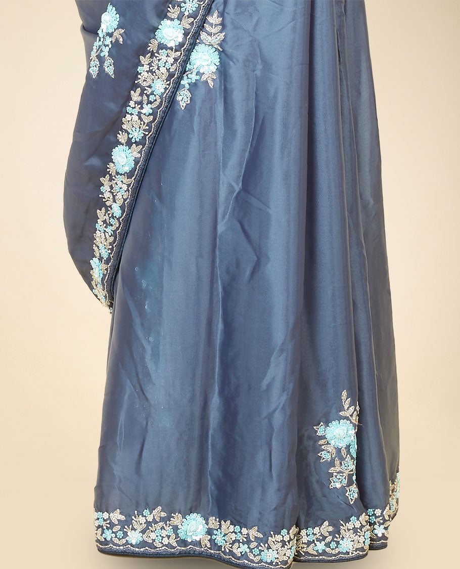 Grey embroidery satin silk saree bedecked with blue colour floral designs all over its body & pallu, embroidery border