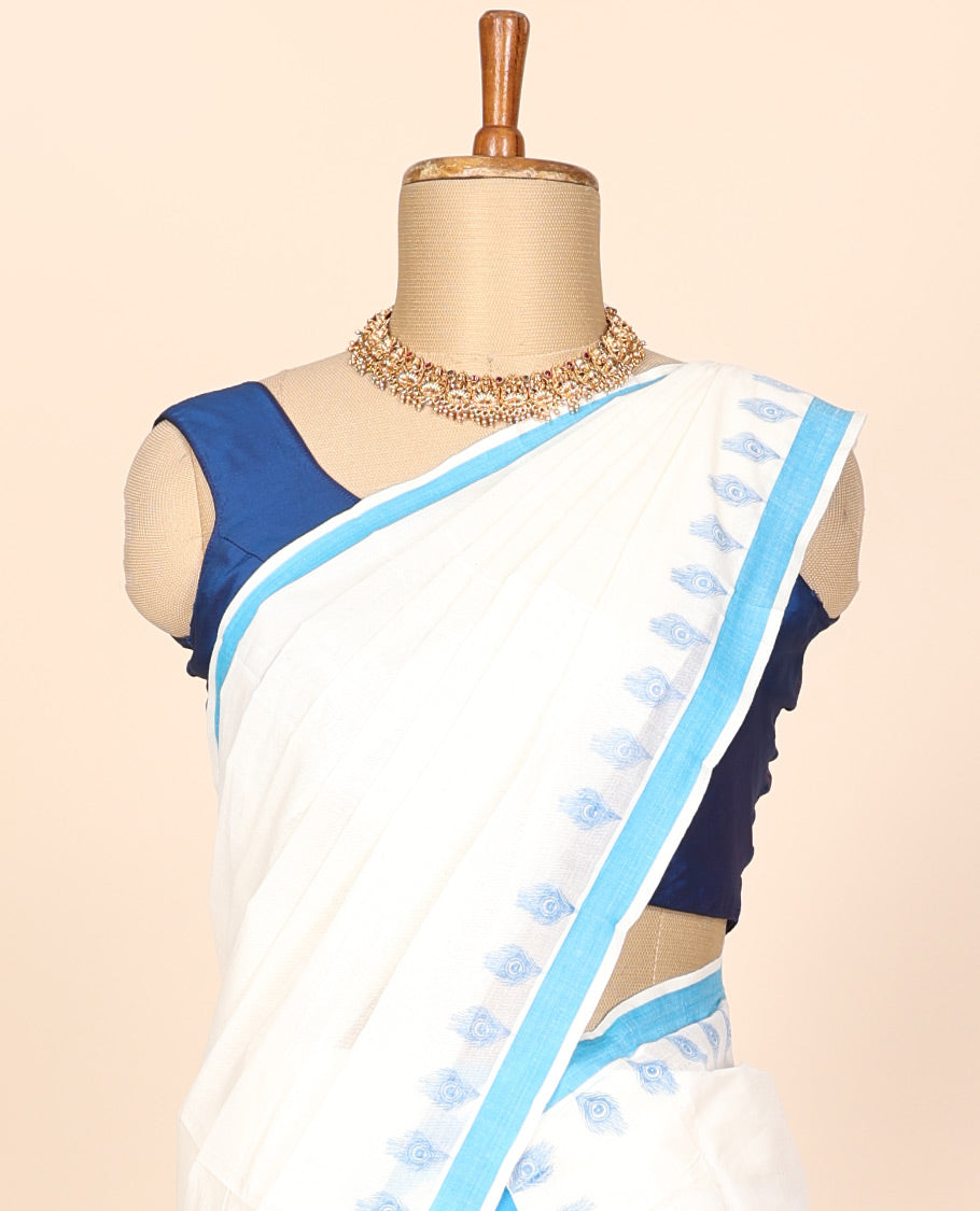 Cream printed kerala mundu set features peacock feathers & contrast blue border