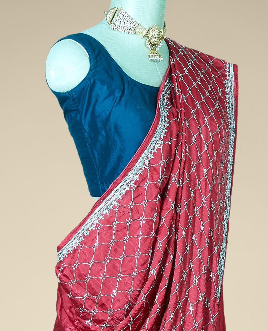 Wine red bridal saree features crystal stone embroidered ogee pattern all over its body, stone work border