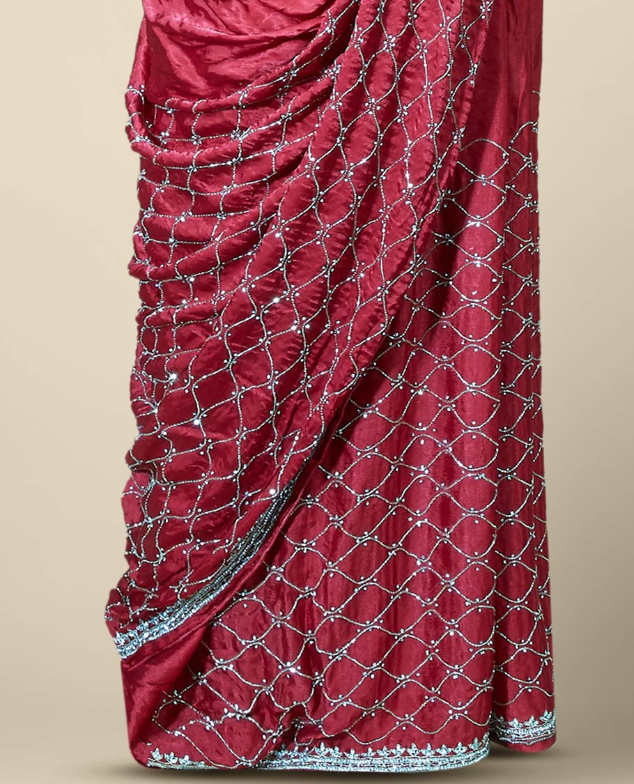 Wine red bridal saree features crystal stone embroidered ogee pattern all over its body, stone work border