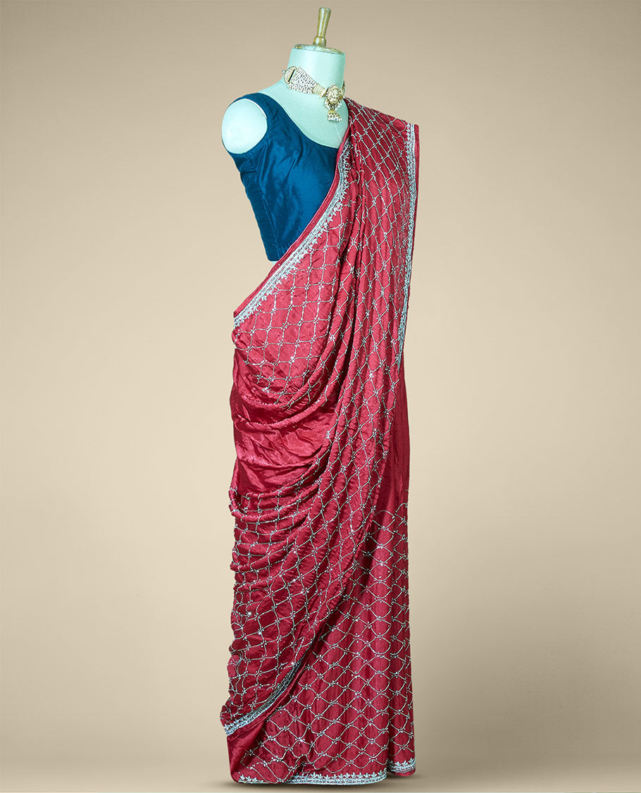 Wine red bridal saree features crystal stone embroidered ogee pattern all over its body, stone work border