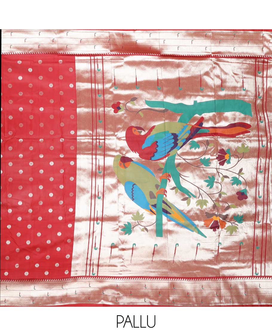 Red semi-paithani saree with buttas, contrast muniya border & pallu features multi-color floral vine & macaw parrots