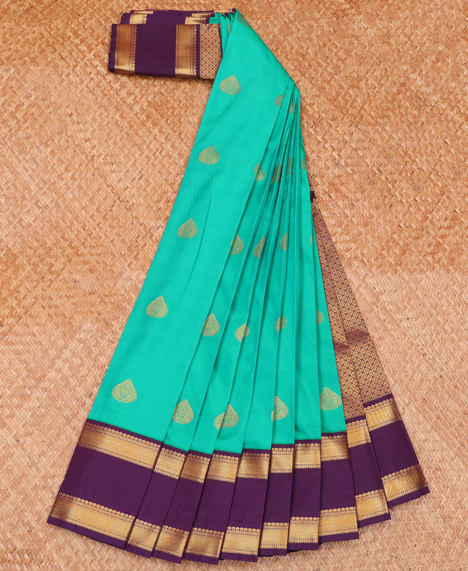 Green Budget Silk Saree Ornamented with Zari Buttas, Highlighted with Contrast Traditional Zari Design Woven Rettai Pettu Border, Zari Elevated Jaal Pallu, and a Paired with a Contrast Blouse