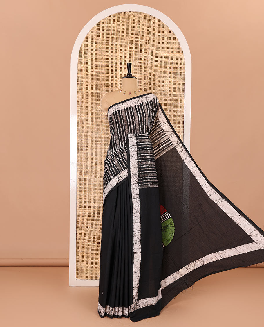 Black batik vertical stripes printed mul cotton saree, batik printed border, pallu of multi-color circle design, and a contrast batik printed blouse