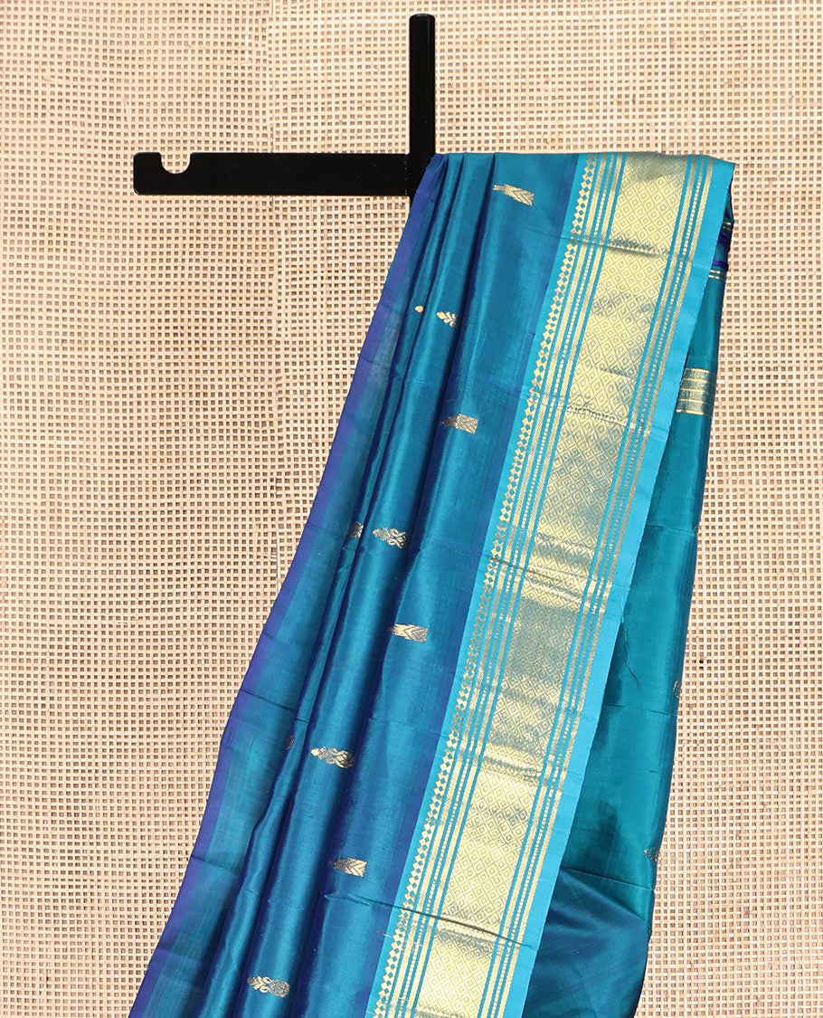 Blue Kanchipuram Silk Saree, Adorned with Zari Buttas, Complemented by a Contrast One-Sided Border of Panner Sombu, Banaras, Muthu, and Mayil Kann Designs, Grand Pallu, and No Blouse
