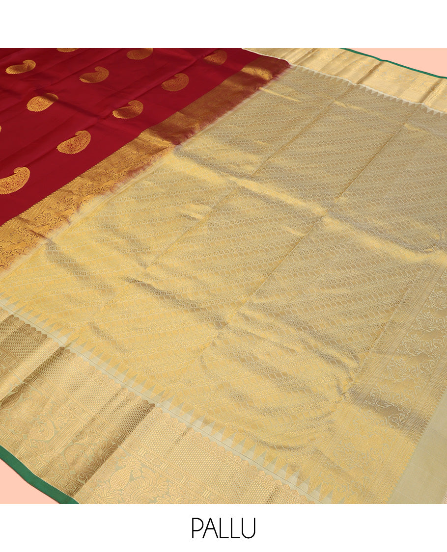 Maroon Vasundhara Silk Saree, Adorned with Arumbu Manga Buttas All Over Its Body, Complemented by Contrast Border of Thilakam Mokku, Mayil and Mayil Kann Designs, Grand Pallu and Paired with a Contrast Blouse