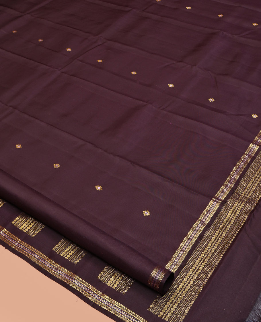 Brown Kanchipuram Silk Saree, Delicately Woven with Zari Buttas All Over Its Body, Highlighted by a Zari Border of Salngai, Muthu, and Rekku Designs, Pallu of Intricate Designs, and Paired with a Matching Blouse