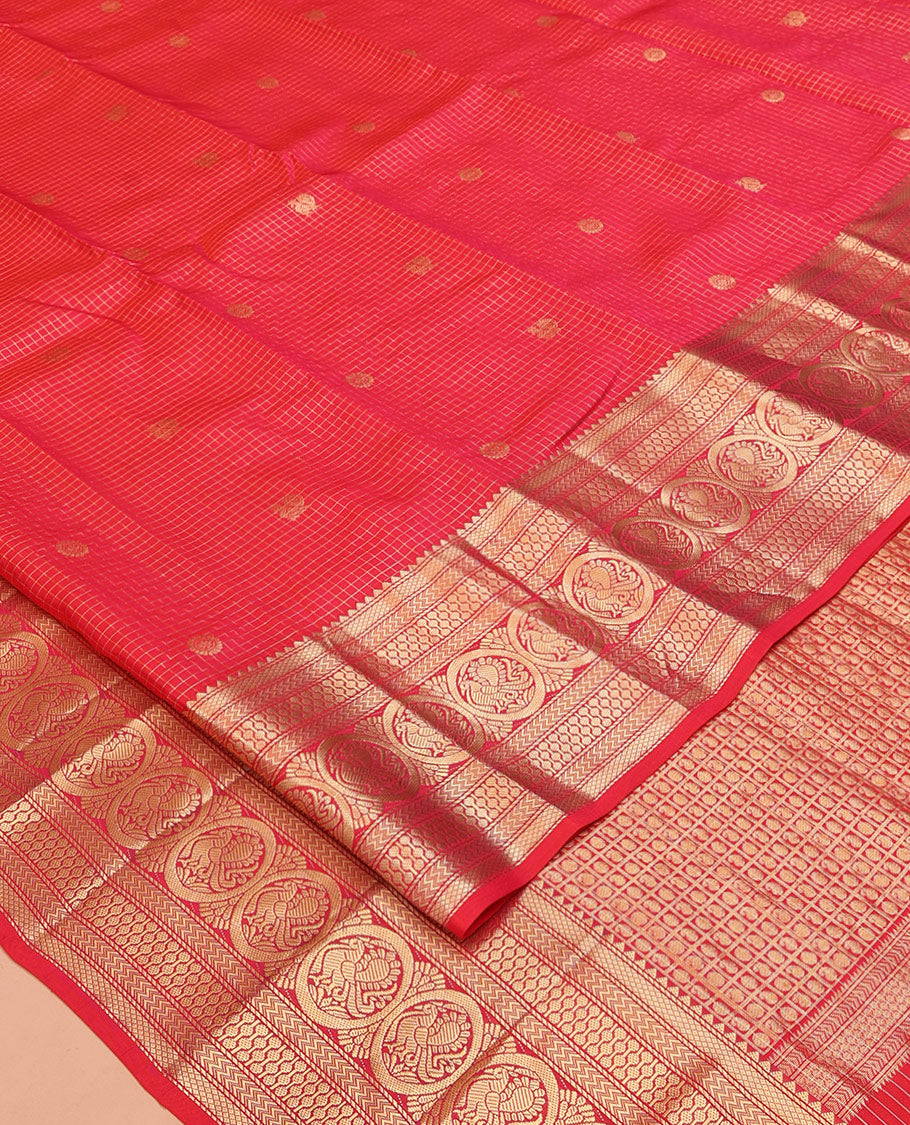 Red Vasundhara Silk Saree, Enriched with Zari Buttas and Checks All Over Its Body, Highlighted by Zari Border of Rekku, Mayil Kann, Vanki, Then Kuli Kann, and Round Mayil Designs, Grand Pallu of Butta Enclosed Checks, and Paired with a Matching Blouse