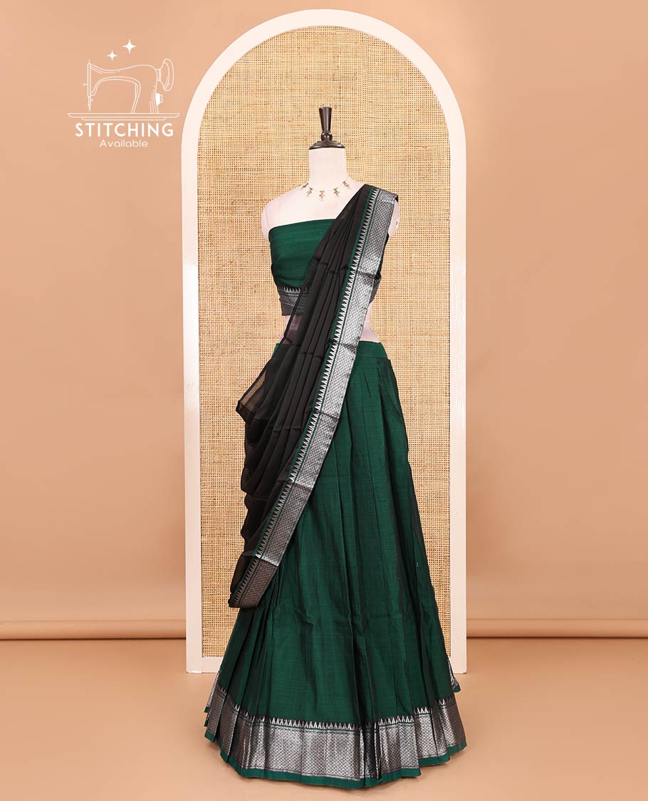 Bottle green Mercerised cotton half-saree, plain & contrast mayil kann temple border skirt, matching blouse & contrast zari border syska georgette dhavani